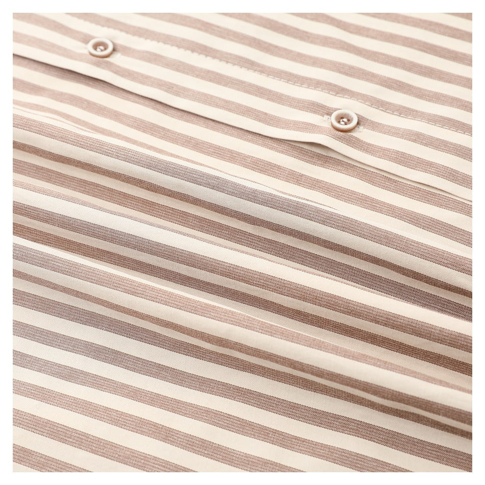 Close-up of a cream shirt with narrow taupe stripes and two buttons on the placket.