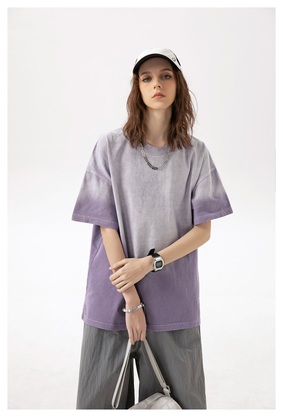 Model wearing a loose lavender and purple washed short-sleeve T-shirt, shown from the front.