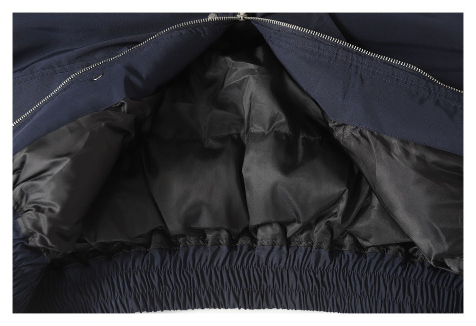 Close-up of the open navy jacket interior, showing black lining and a gathered elastic hem.