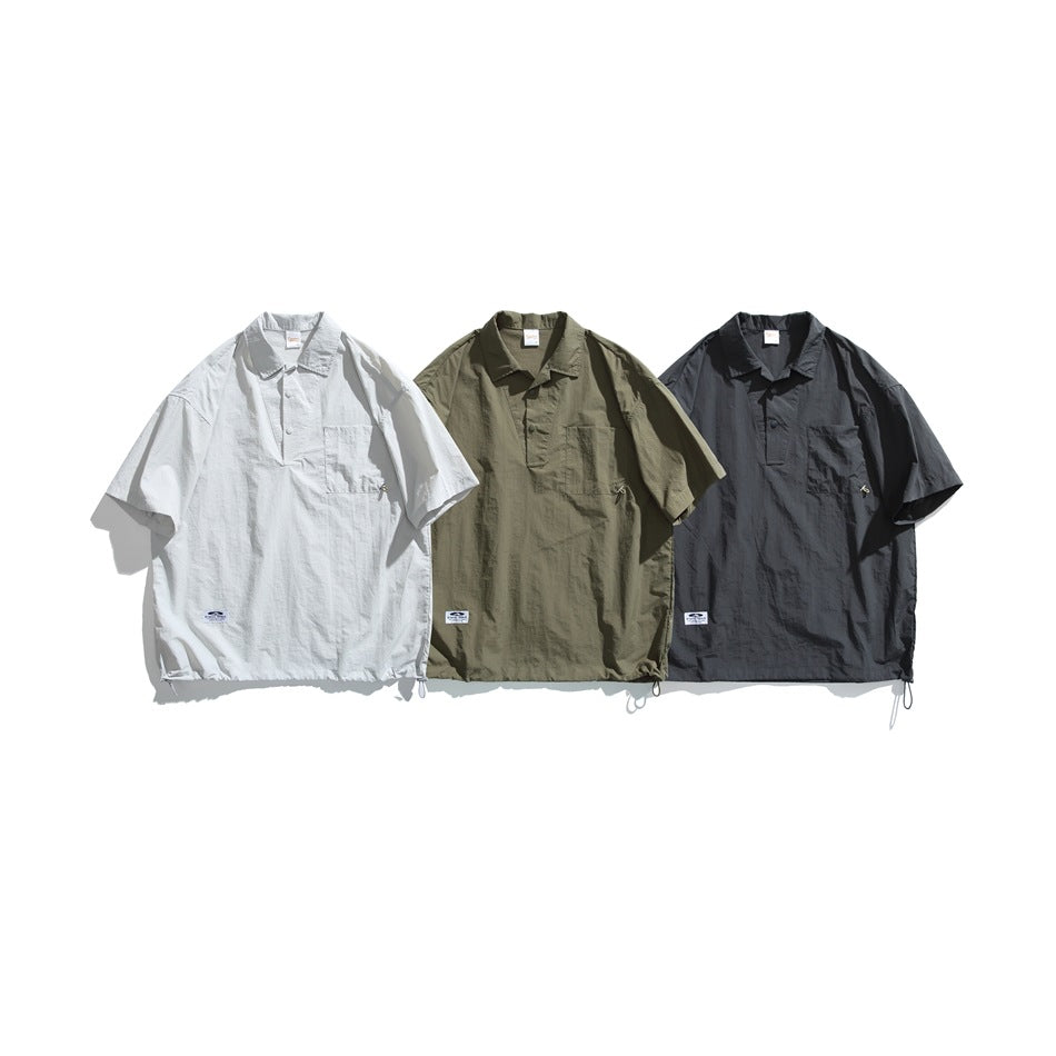 Three short-sleeve pullover shirts shown from the front in pale gray, olive green and charcoal, each with a collar and chest