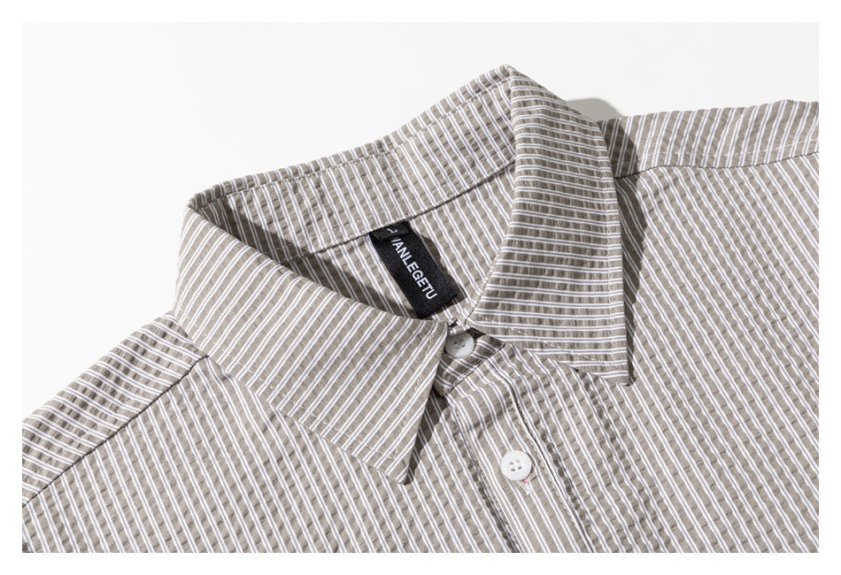 Close-up of the striped shirt's pointed collar, neck label, and upper button placket.