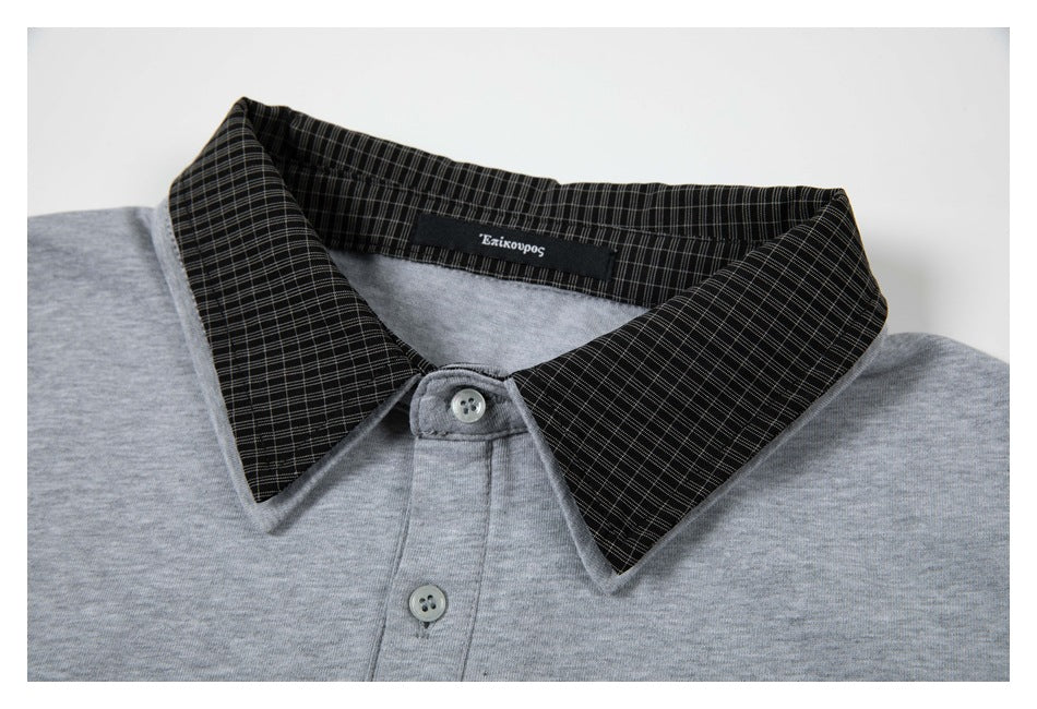 Close-up of a heather-gray polo collar with black fine-check fabric and a two-button placket.