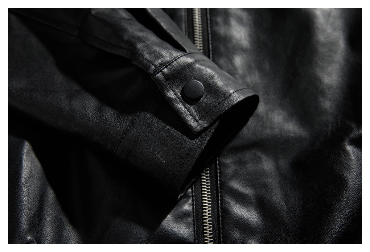 Close-up of a black jacket cuff with a snap button beside a metal zipper.