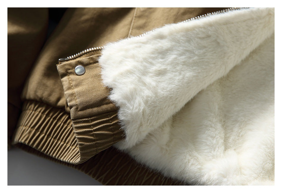 Close-up of the jacket's plush white lining beside a tan sleeve cuff with a snap and zipper.