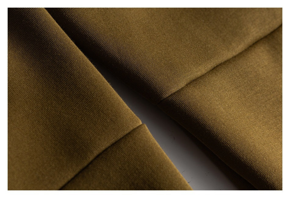 Close-up of olive-brown pant fabric and stitched seam details.