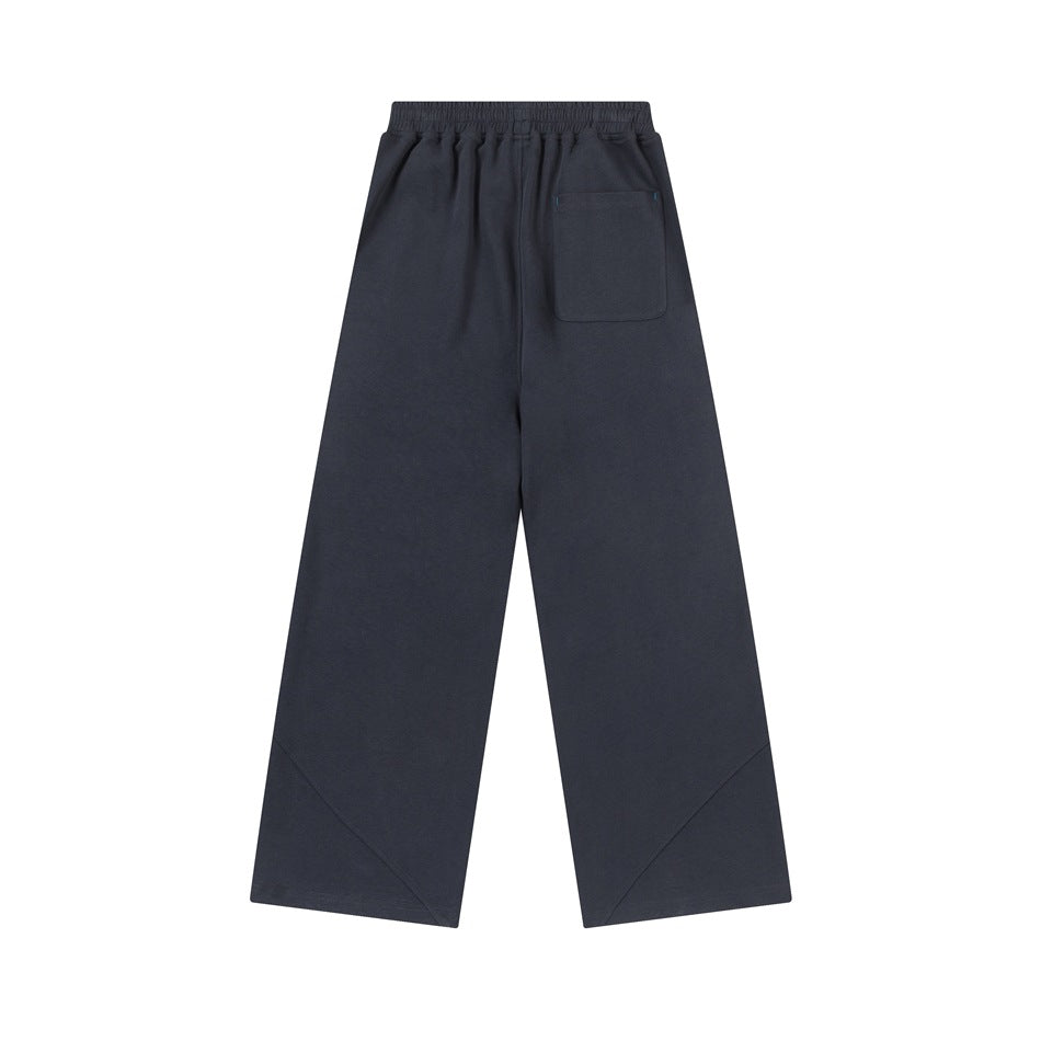 Back view of charcoal wide-leg pants with an elastic waist and a single patch pocket.