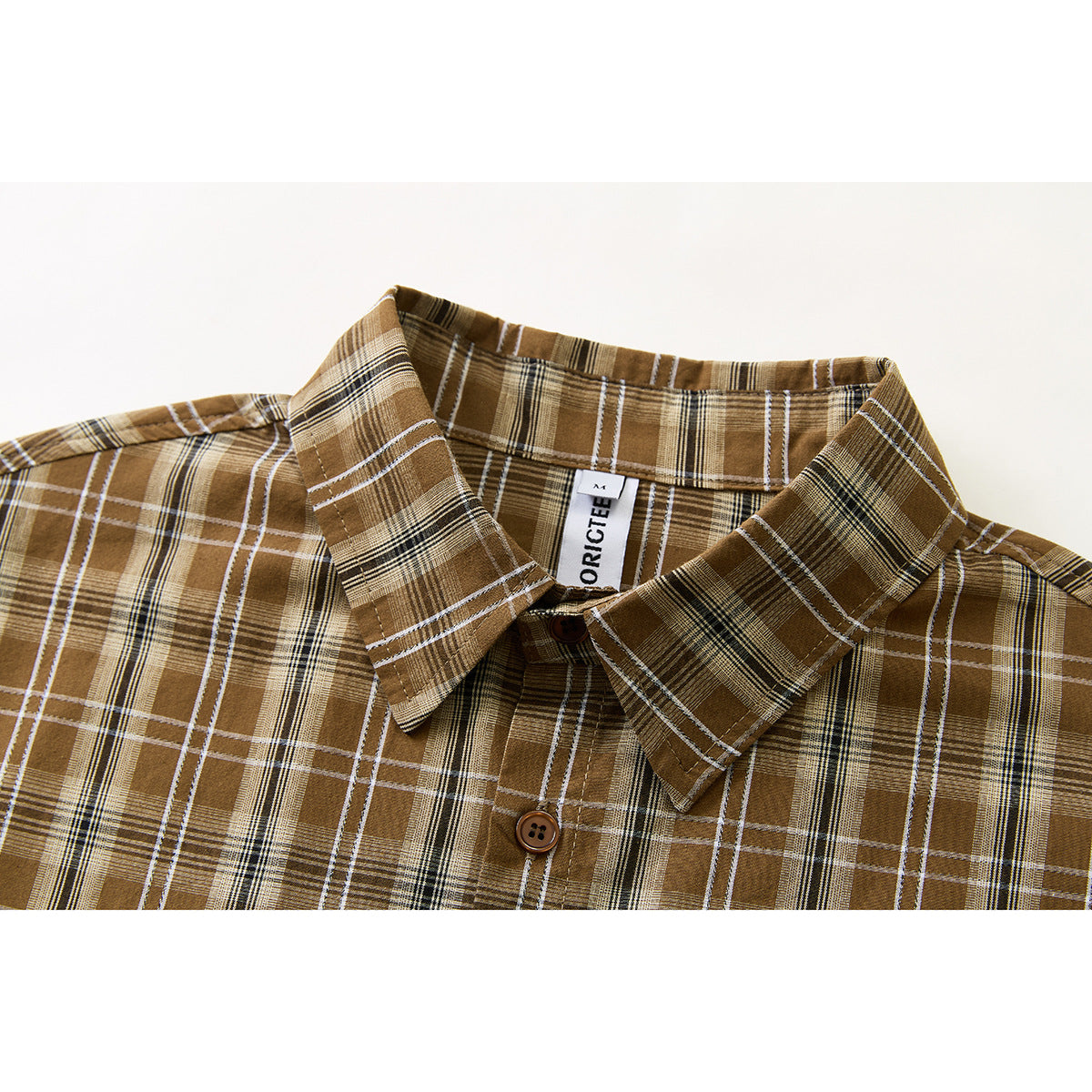 Close-up of a brown plaid shirt collar, button placket, and sewn-in neck label.