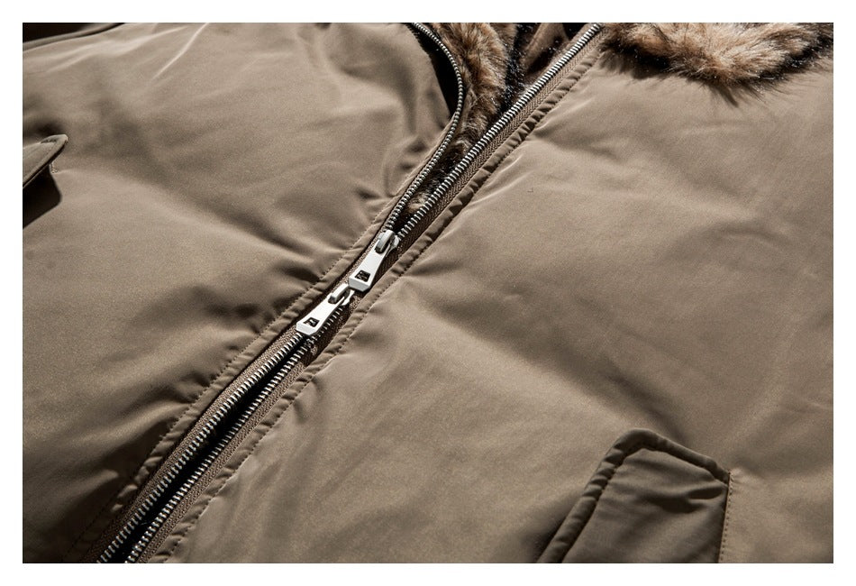 Close-up of the taupe jacket's double zipper and brown faux-fur hood trim.