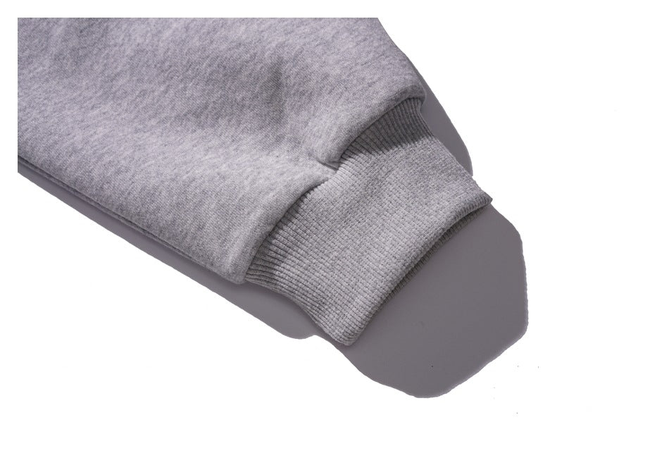 Close-up of a gray sweatshirt sleeve ending in a ribbed cuff.