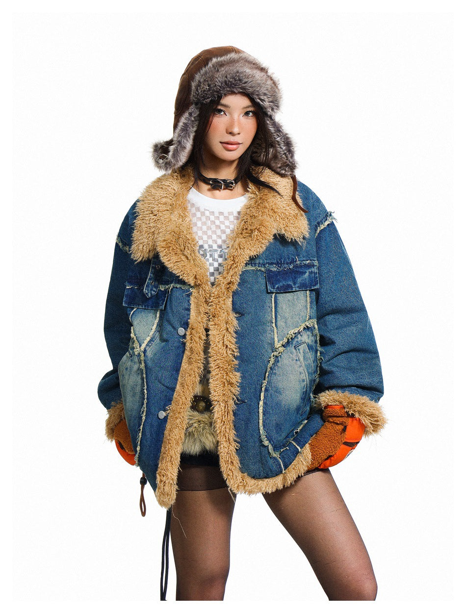 Model wearing a blue patchwork denim jacket with tan shaggy trim, orange gloves and a fur-lined trapper hat.