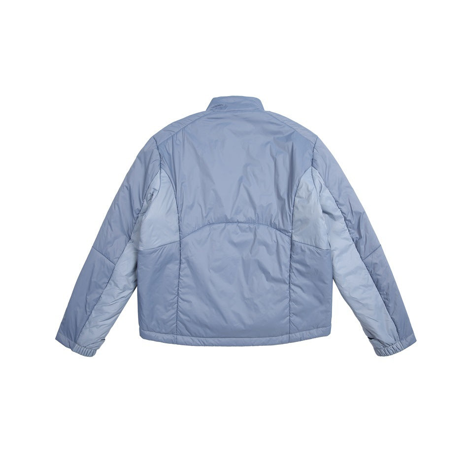 Rear view of a pale blue jacket with a stand collar, panel seams, and elastic cuffs.