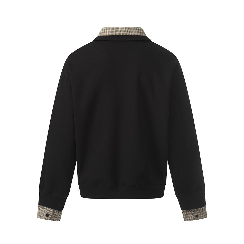 Back view of a black collared pullover with checked fabric at the collar and sleeve cuffs.