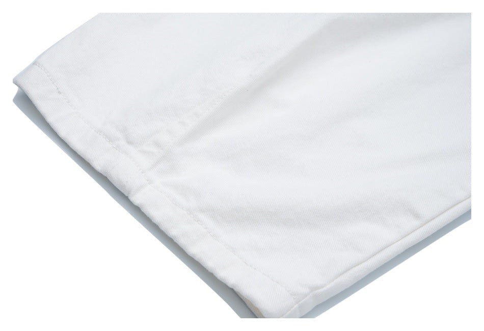 Close-up of a white garment hem with visible stitching and folded edge.