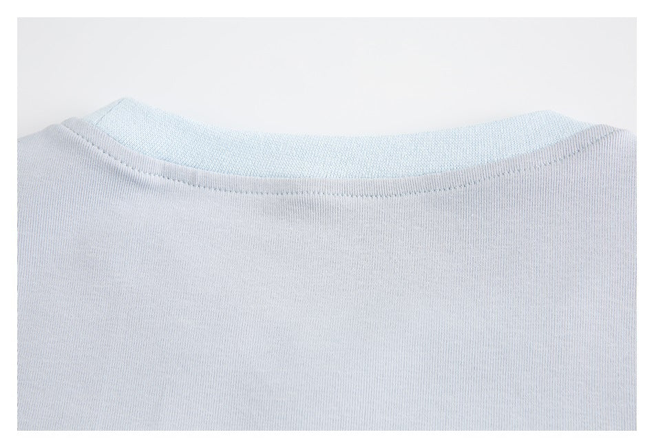 Close-up of the pale blue garment's rounded neckline and stitching.