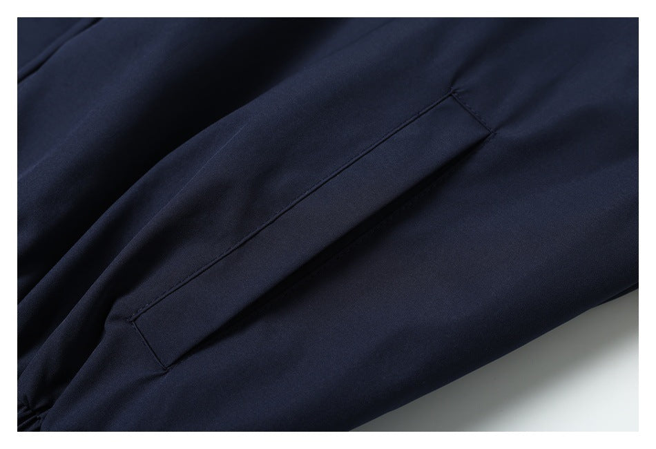 Close-up of a dark navy garment with a long stitched pocket opening.