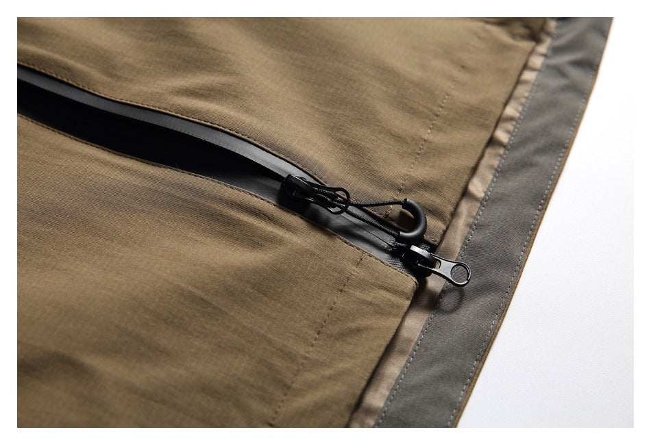 Close-up of a brown jacket panel with a black zipper and gray edge trim.
