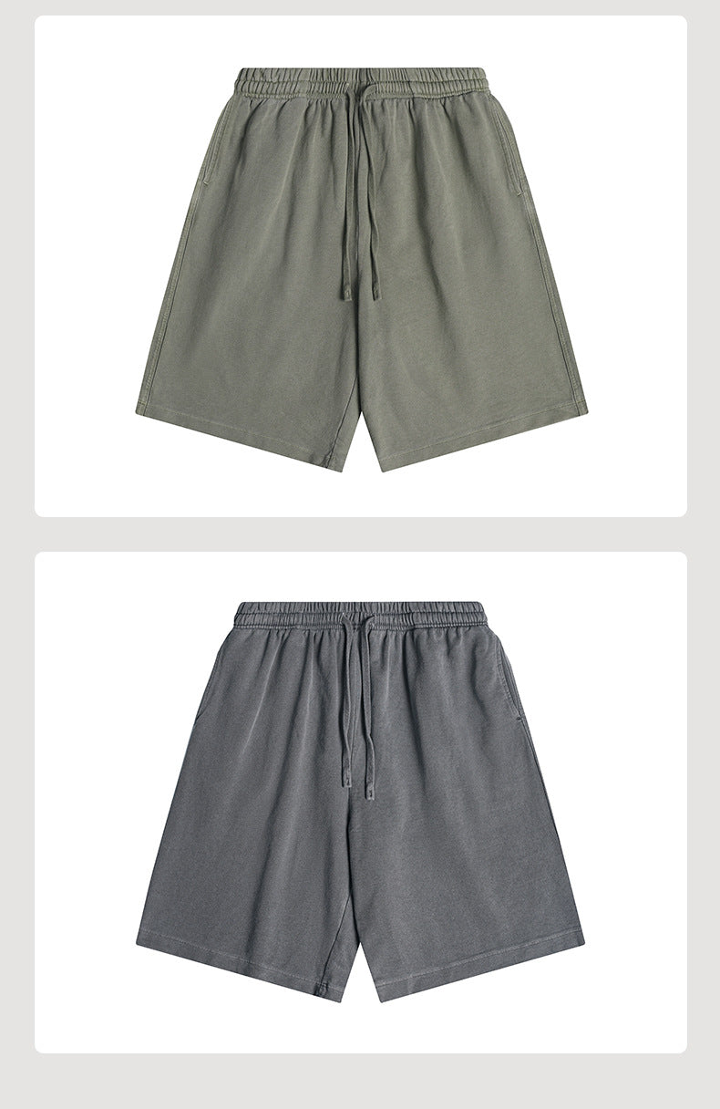 Front flat lays of elastic-waist shorts with drawstrings and side pockets in olive gray and charcoal gray.