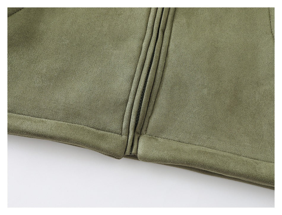 Close-up of olive-green fabric with a stitched seam and narrow zipper along the edge.