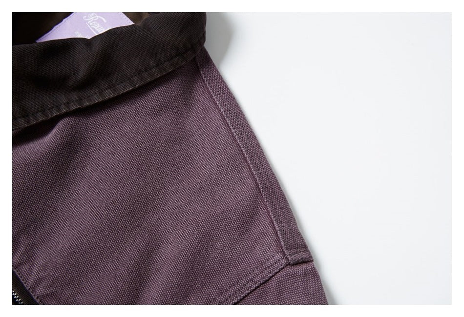 Close-up of the plum-colored jacket fabric, brown collar, and a partial interior label.