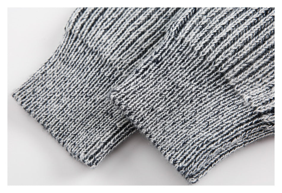 Close-up of two black and white rib-knit edges with narrow finished hems.