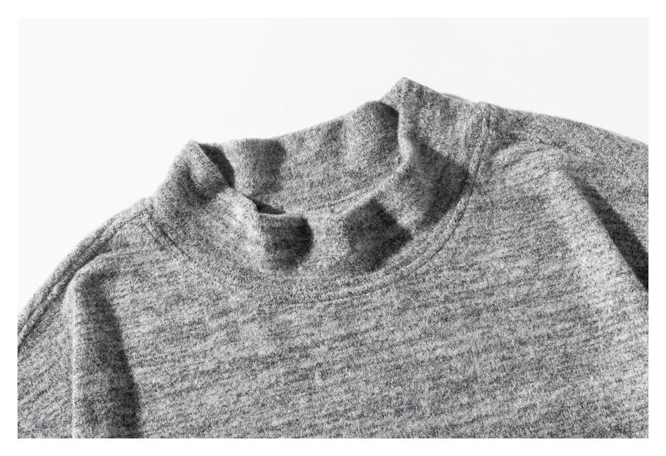 Close-up of the gray marled top's short collar and neckline stitching.