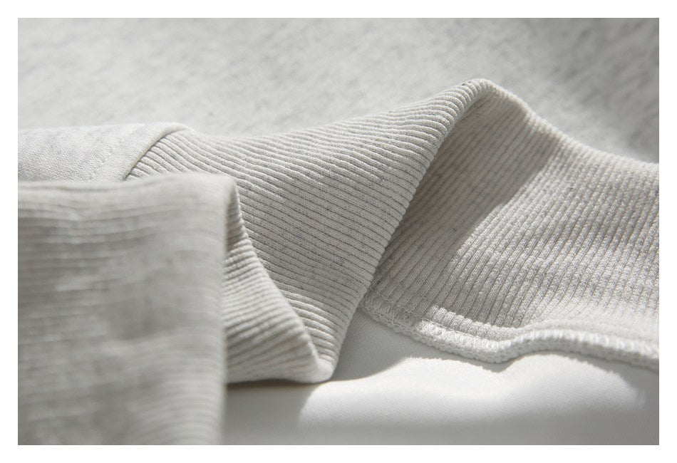 Close-up of ribbed edging on a light gray heather garment.