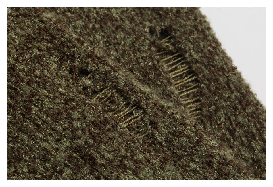 Close-up of brown and olive fuzzy knit showing stitched openings and a seam.