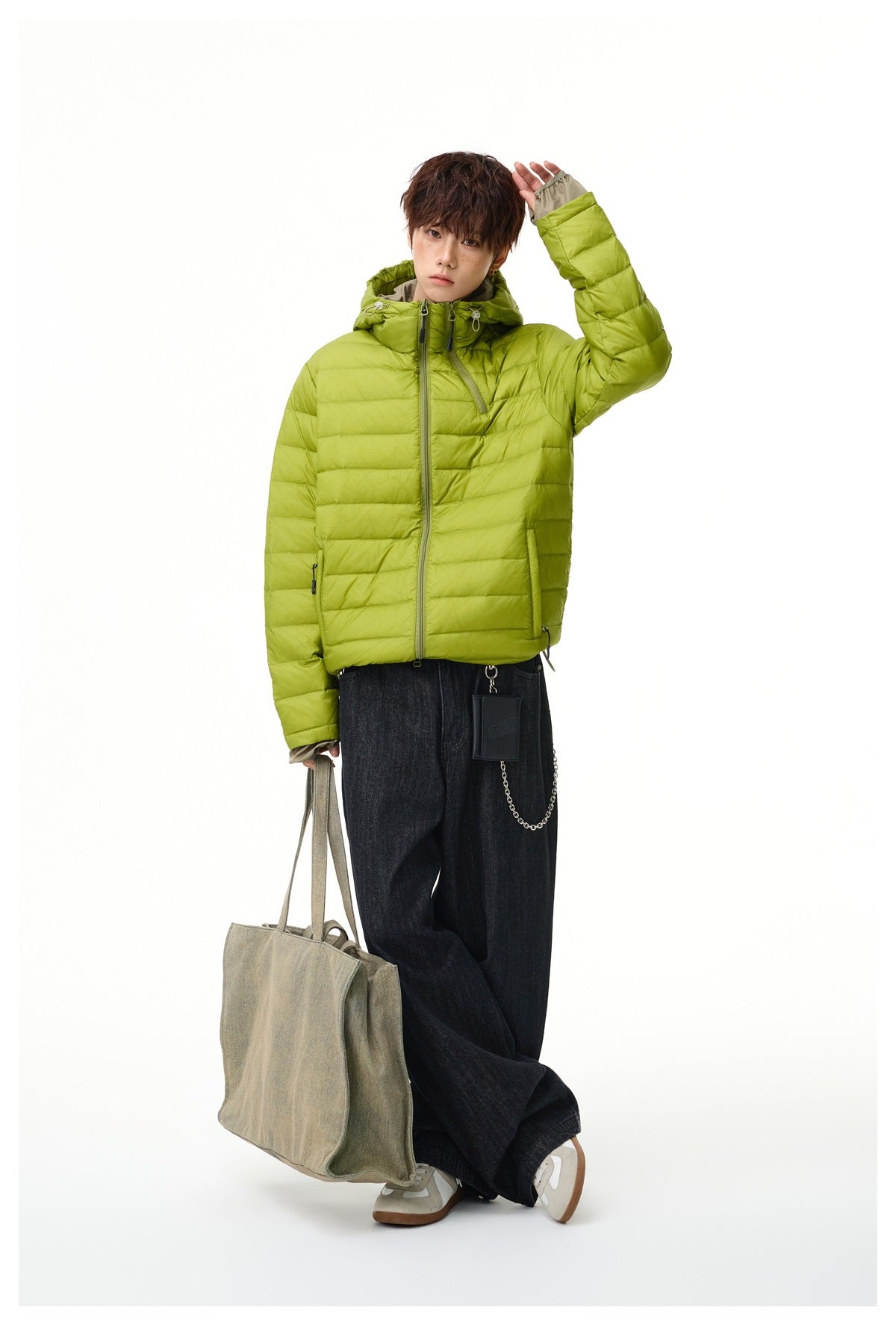 Model wearing a lime green hooded puffer jacket with horizontal quilting and a front zipper.