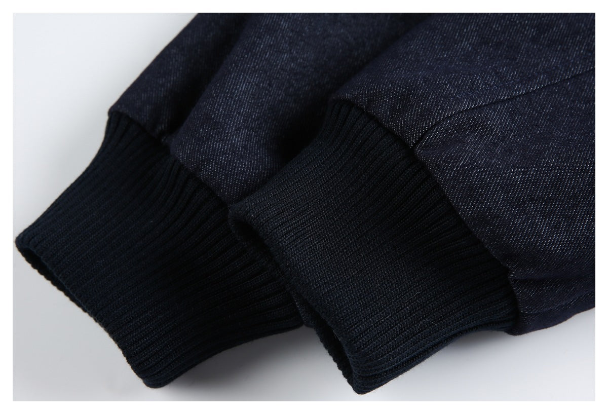 Close-up of a dark indigo garment with wide black rib-knit cuffs.