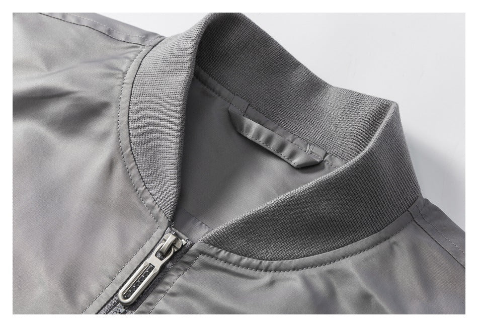 Close-up of the gray jacket’s ribbed collar and front zipper.