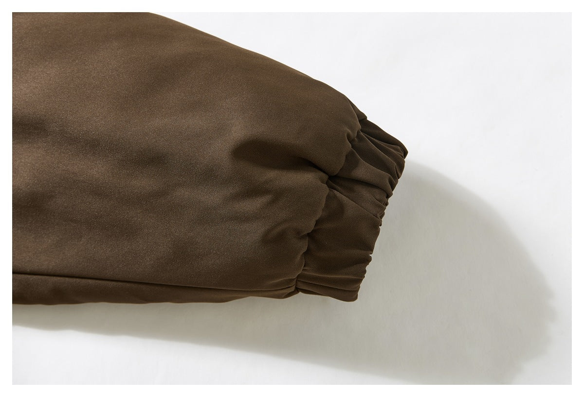 Close-up of the brown jacket sleeve ending in a gathered elastic cuff.