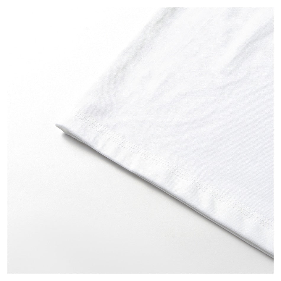 Close-up of the double-stitched hem along the white shirt body.