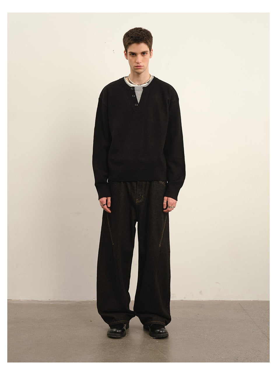 Model wearing a black long-sleeve sweater with a three-button notched neckline and wide-leg black trousers, full-length front