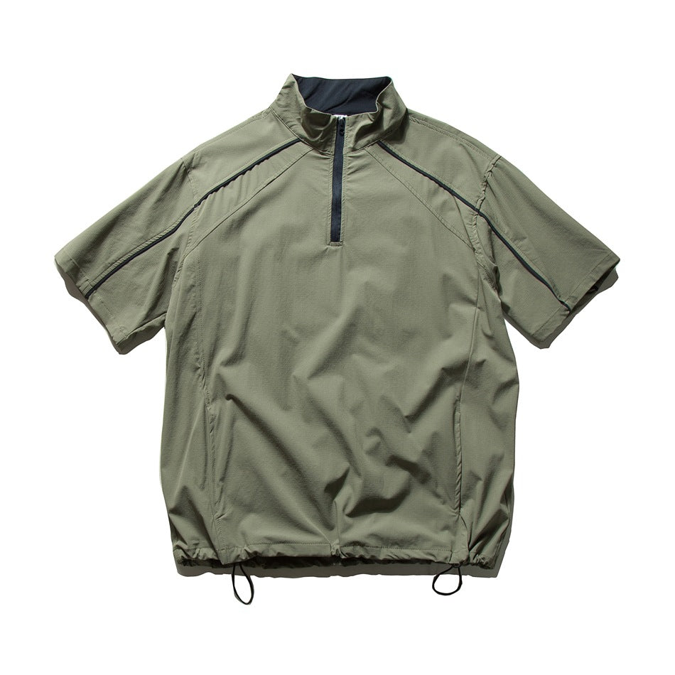 Olive green short-sleeve quarter-zip jacket with stand collar, dark zipper and piping, and drawcord hem, flat lay