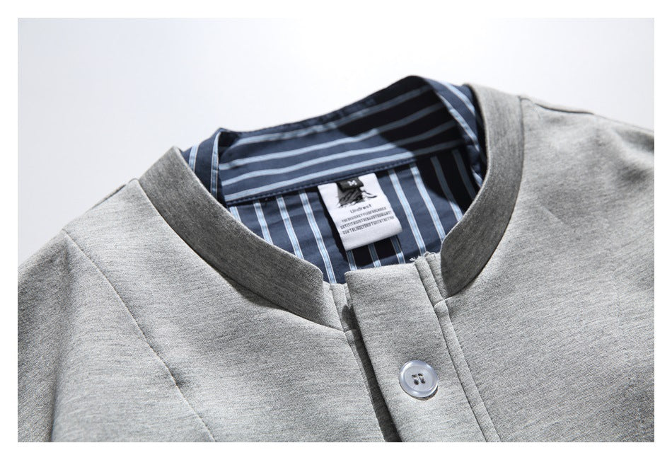 Close-up of the jacket's gray collar, blue striped lining, button, and sewn-in neck label.