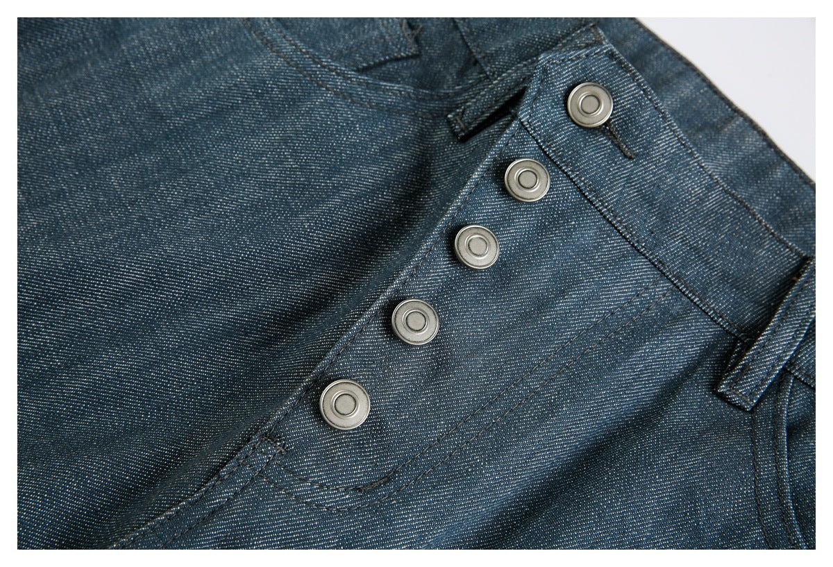 Close-up of the dark blue pants' five-button front closure and stitched waistband.