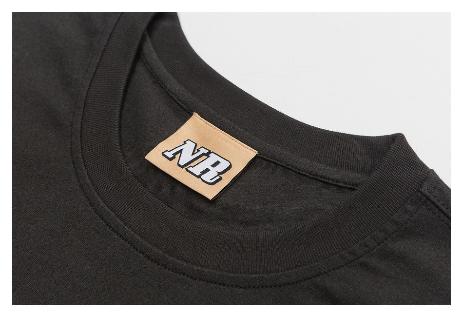 Close-up of a black crewneck collar with a tan label at the neckline.