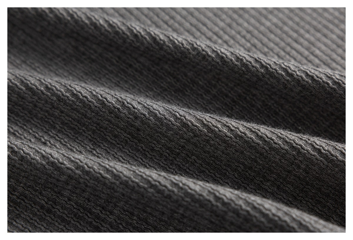Macro view of the gray fabric's raised, wavy knit texture.