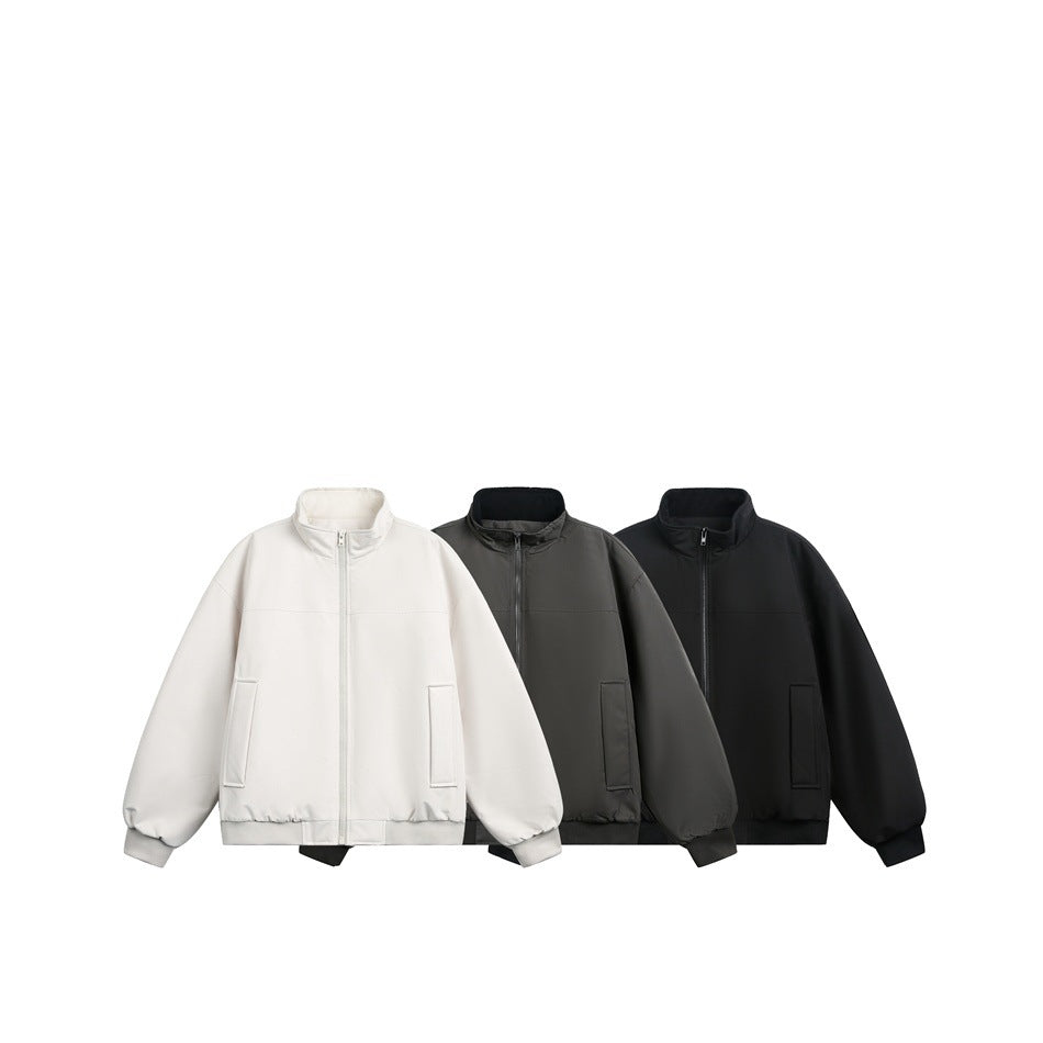 Three front-view zip-up jackets with stand collars and front pockets in ivory, charcoal gray, and black.