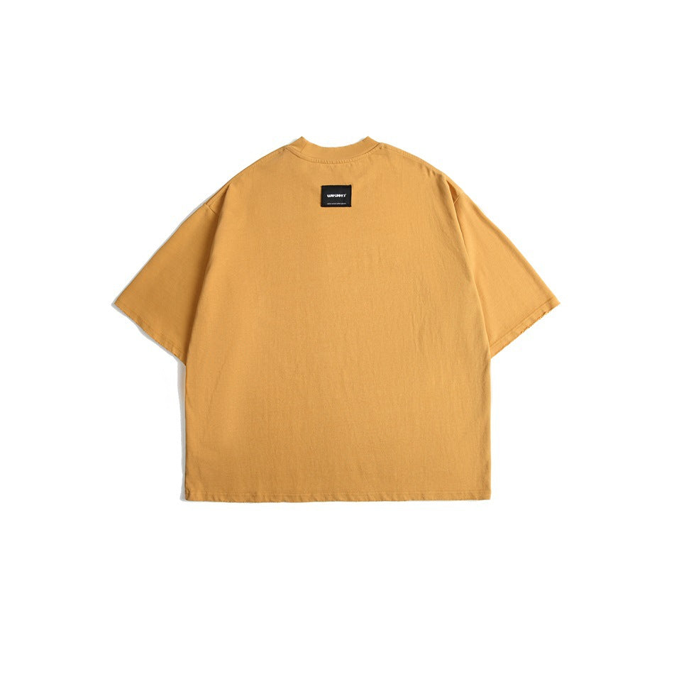 Back view of a golden mustard oversized T-shirt with short sleeves and a small black neck label.