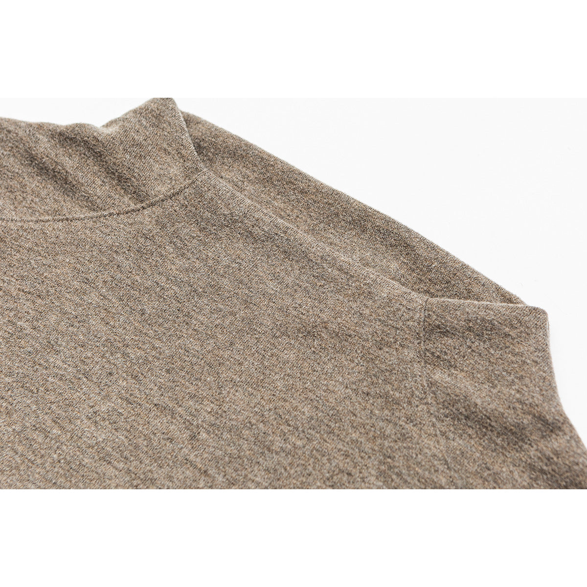 Close-up of a taupe heathered top's high neckline, shoulder seam, and sleeve.