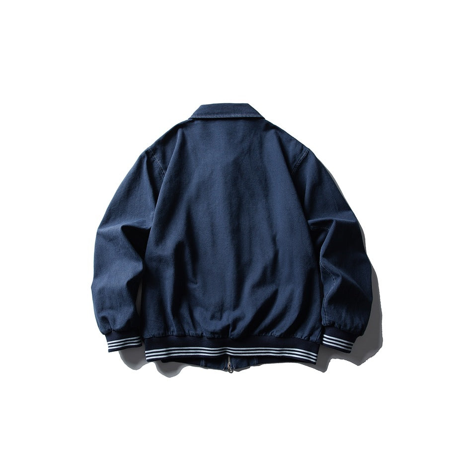 Back view of a navy jacket with a pointed collar and striped ribbed cuffs and hem.