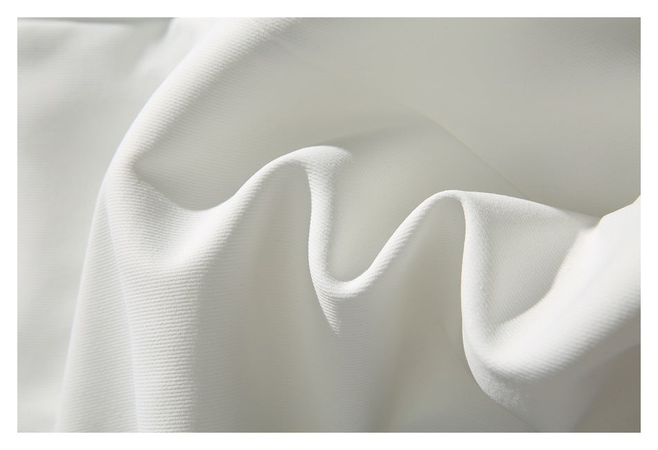 Close-up showing the fine texture and folds of white garment fabric.