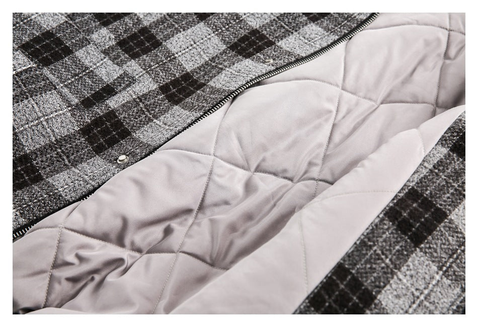 Open plaid garment showing pale quilted lining, a zipper, and snap fasteners.