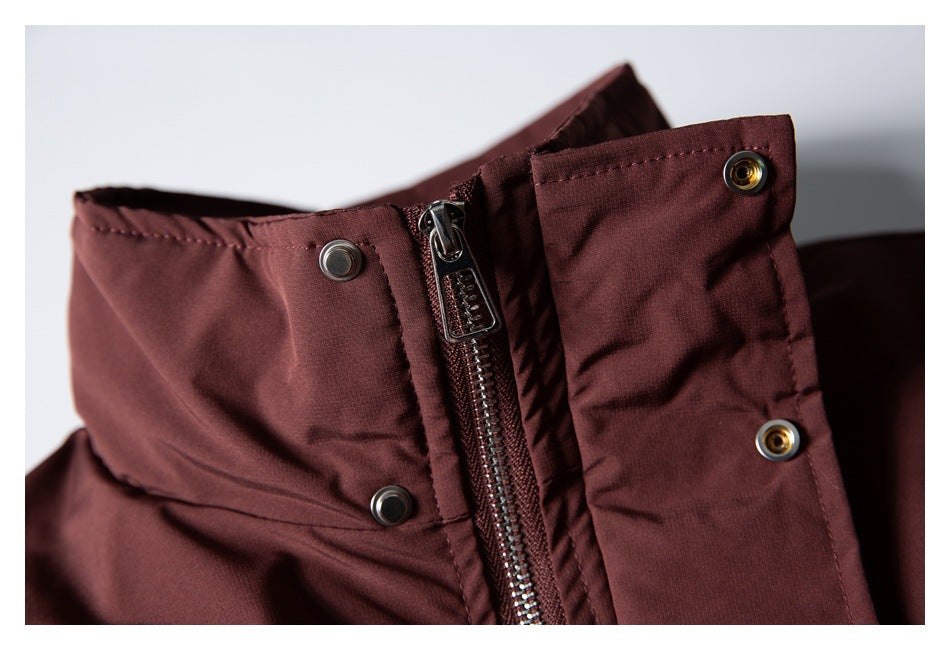 Close-up of the burgundy jacket zipper and snap-fastening front placket.