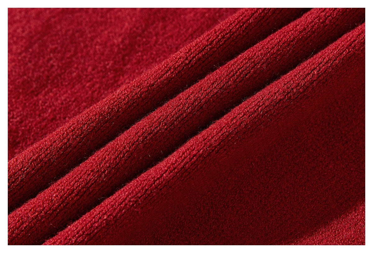 Close-up of deep red fabric folded into ridges, showing its textured surface.