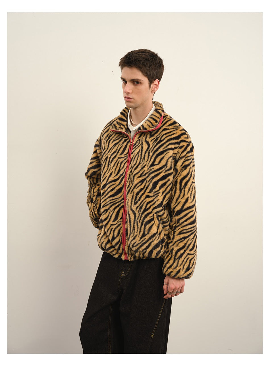 Three-quarter view of a model wearing a tan-and-black tiger-stripe zip fleece jacket with red trim.