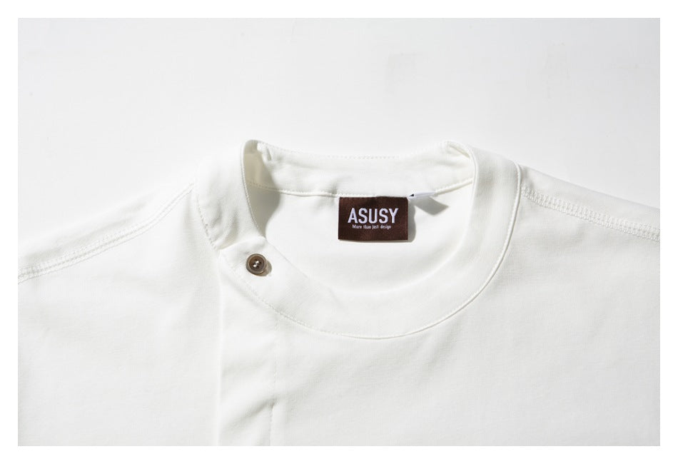 Close-up of a white shirt’s round neckline, single-button detail and sewn neck label.
