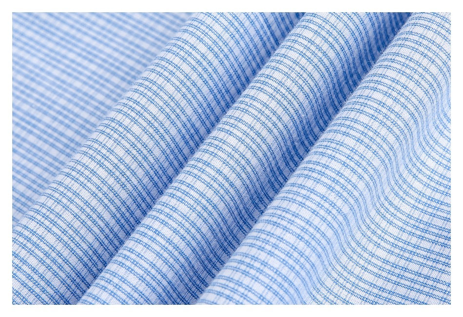 Close-up of blue-and-white finely checked fabric draped in soft folds.