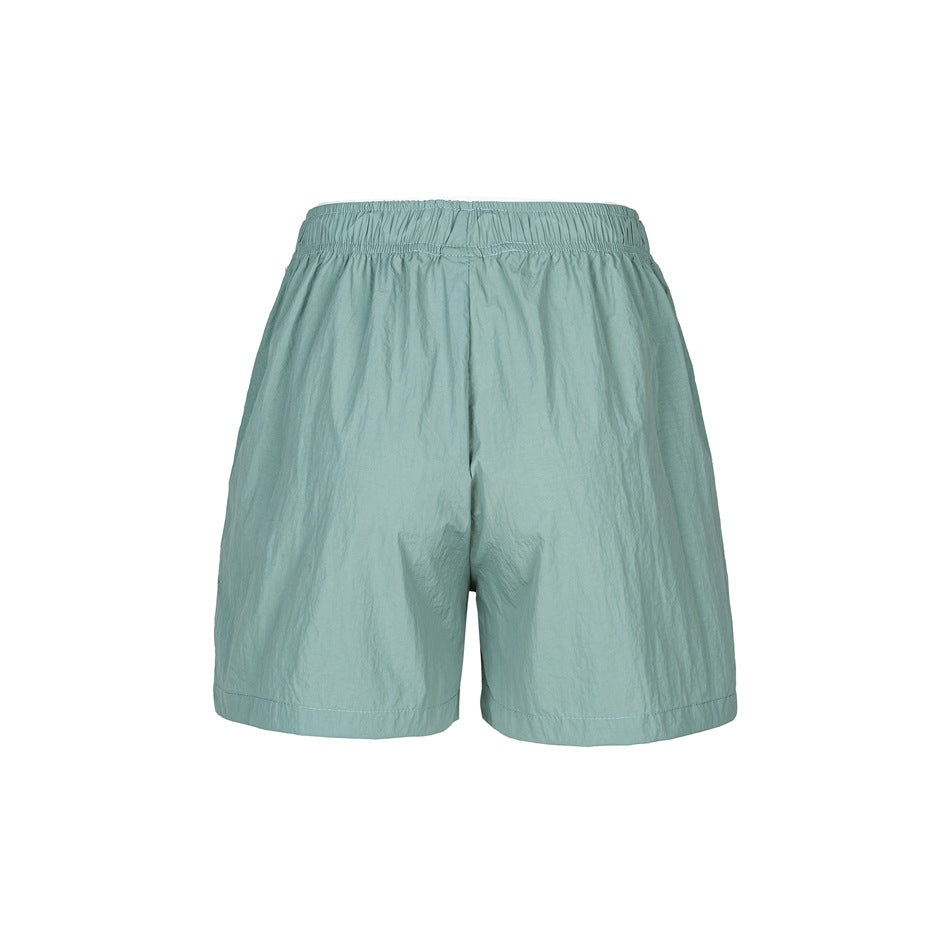 Back view of green crinkled shorts with elastic waistband and straight short legs